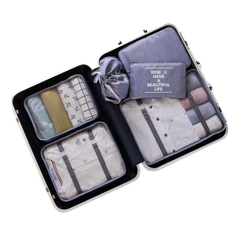 suitcase neatly packed with clothing items in organised compartments and packing cubes, labelled for efficient travel with luggage.