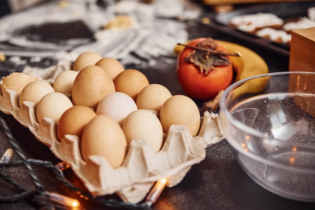 Eggs, milk, and fruits on a counter. What can you cook in an air fryer? Easy breakfast eggs.