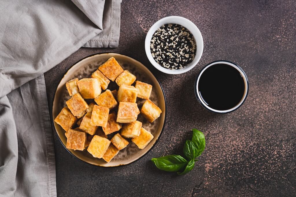 Golden tofu cubes with sesame seeds and dipping sauce. What can you cook in an air fryer? Air-fry crispy tofu.