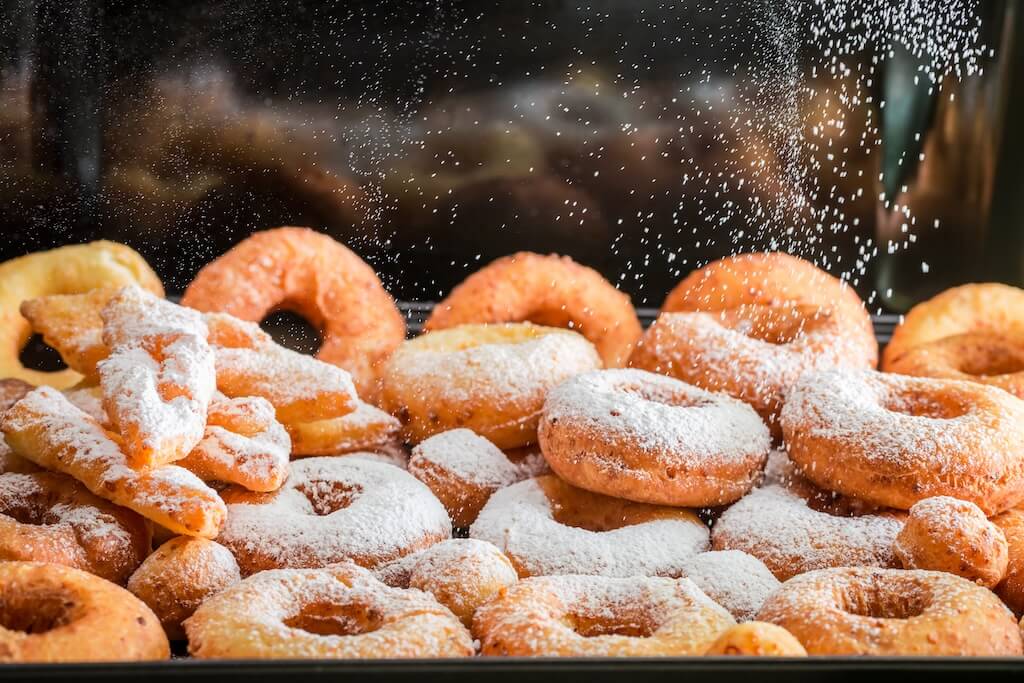 Fresh donuts dusted with powdered sugar. What can you cook in an air fryer? Healthier air-fried donuts.